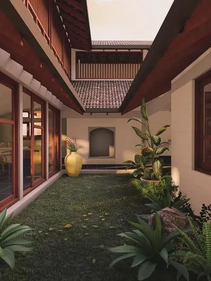 The internal courtyard of the laterite villa acts as a green lung for the home. Lined with large glass windows and doors, it blurs the line between the living spaces and the garden, ensuring nature is always in view.