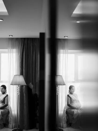An artistic black and white photo using reflections to create a powerful and contemplative portrait of the mother-to-be.