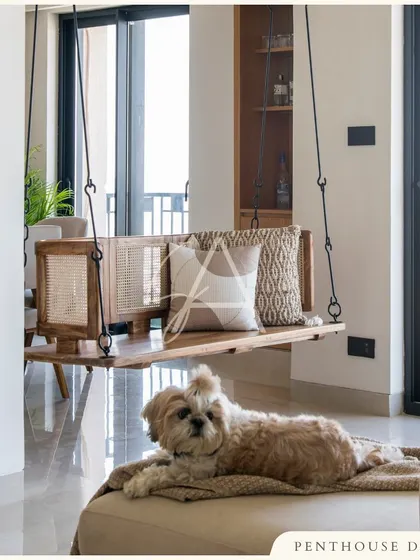 Another view of the indoor swing, this time showing its connection to the balcony. The design brings natural elements like wood and rattan indoors, blurring the line between inside and out.