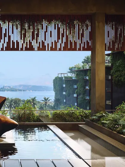 A view from within the Westin Nashik, looking out towards the water. The design uses architectural framing and integrated planters to blur the boundary between the interior space and the breathtaking natural scenery outside.