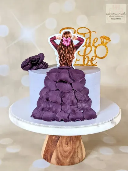 This popular "dress on a cake" design is perfect for a bride-to-be. The flowing gown is created with individually placed fondant petals, giving it a beautiful, textured look.