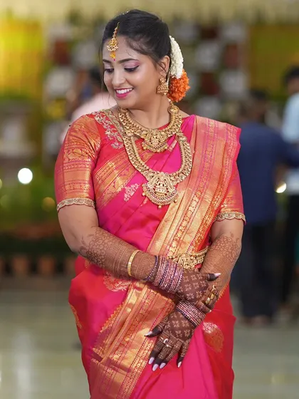 This bride is glowing in her bright pink reception saree. The drape is classic and clean, allowing her to move comfortably and enjoy her special evening.