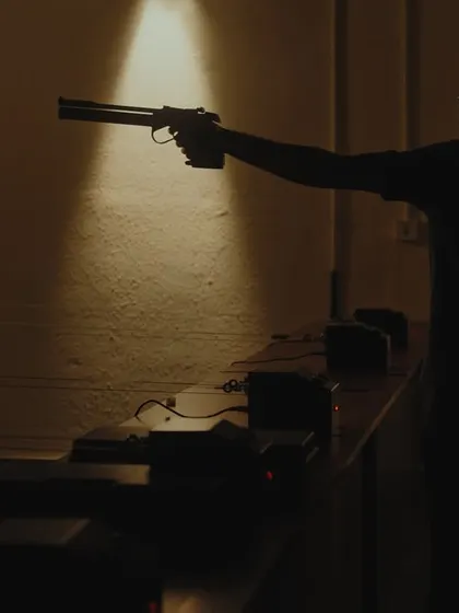 Another powerful, atmospheric shot of a shooter taking aim. Our ranges provide the perfect setting to hone your skills.
