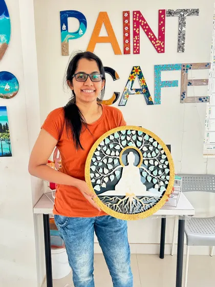 A smiling participant with her beautiful Buddha-themed texture art piece.