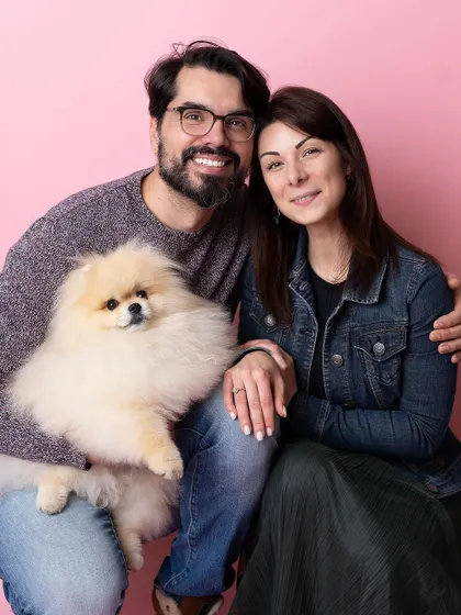 A lovely couple poses with their fluffy Pomeranian at the launch party for a new pet grooming salon. I love setting up photo booths to capture the joy of pets and their people at events.