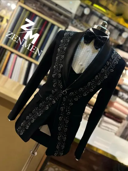 A side-angle shot of the black and silver leaf tuxedo, showcasing the design's flow and the suit's sharp tailoring.