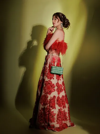 A full-length shot showing the dramatic silhouette and the beautiful makeup. The look is both artistic and glamorous.