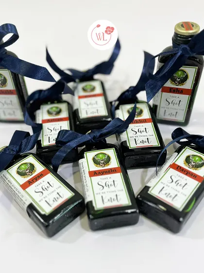 "Take a shot, we're tying the knot!" These personalized miniature bottles are a fun and popular favor for the groomsmen to enjoy during the celebrations.