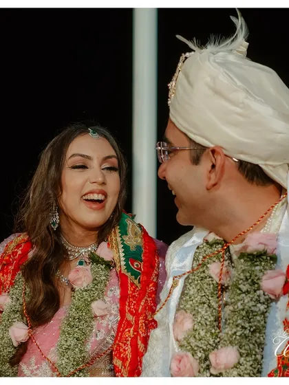 A burst of laughter from the couple, a candid moment of pure happiness.