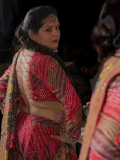 A reflection shot showing the intricate criss-cross tie-back of a custom Navratri blouse.