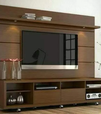 A classic wooden TV unit with ample storage. This freestanding piece offers both open shelves for devices and closed cabinets to hide clutter.