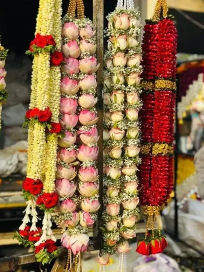 I specialize in creating all types of fresh flower garlands. This photo shows some of my premium garlands, including ones made with lotus buds, roses, and jasmine, perfect for the bride and groom or for decorating deities.