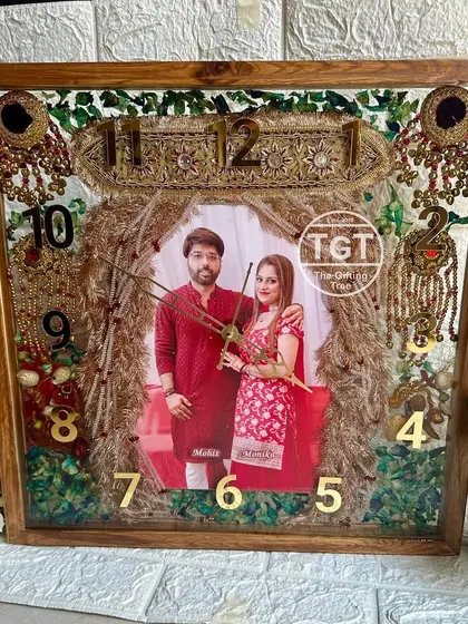 A full, straight-on view of the grand teakwood clock. It's a functional clock and a comprehensive wedding keepsake that captures multiple rituals.