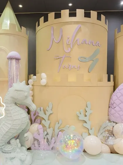 The stunning underwater castle I designed for Mihana's mermaid party, complete with a seahorse statue, coral details, and a mermaid tail accent.