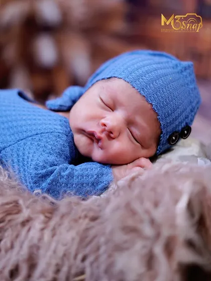 The classic "chin on hands" pose is a favorite for a reason. It perfectly shows off the baby's sweet, round cheeks and peaceful expression.