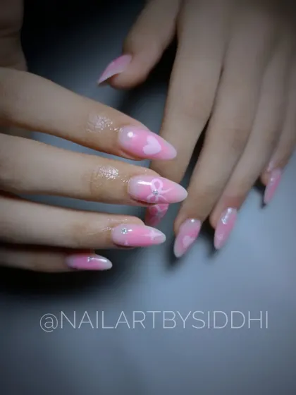 A close-up of the pink blossom nail art, highlighting the delicate details.