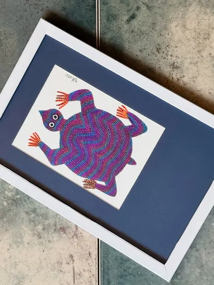 This colourful Bhil art piece, featuring a tortoise, showcases the vibrant, dotted style characteristic of the tribe's artists. Each piece tells a story and supports the artisans whose skills are woven into their creations.