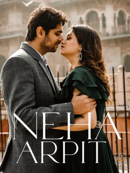 An intimate pre-wedding portrait set against the classic architecture of Jaipur, capturing a quiet moment between the couple.