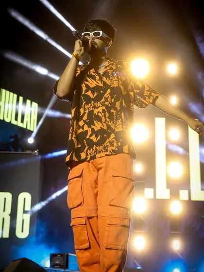KhullarG owning the stage at Social Nation. This shot captures his confident stage presence against a backdrop of bright stage lights.