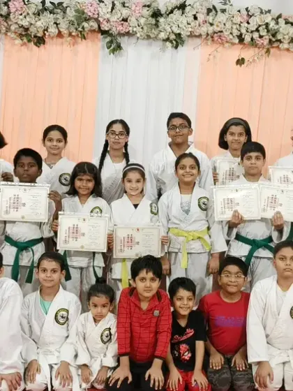 A large group photo from our belt and certificate distribution at Rejoice International School, another one of our valued school partners.