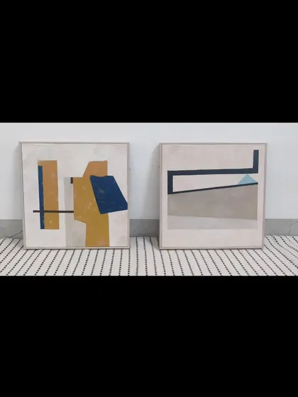 A custom set of two abstract paintings. Each piece has its own unique composition but is linked by a shared color scheme of mustard yellow, deep blue, and neutral grays, designed to be displayed together.