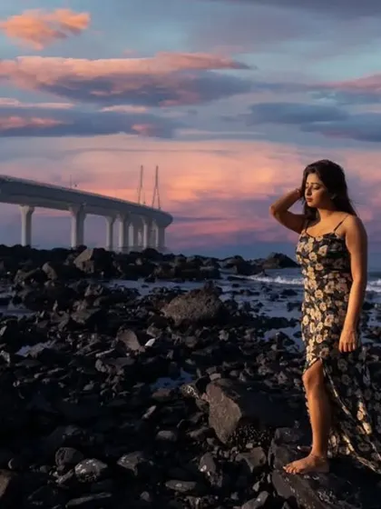 The dramatic Mumbai skyline meets a moment of quiet contemplation. This portrait uses the stunning sunset and the iconic Bandra-Worli Sea Link to create a cinematic and atmospheric fashion shot.