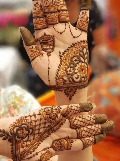 This design combines different elements, including a traditional hanging jhumka motif and a floral Arabic bail.
