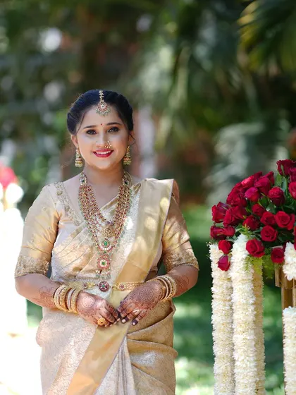 A beautiful client on her wedding day, wearing a grand layered temple jewellery set.