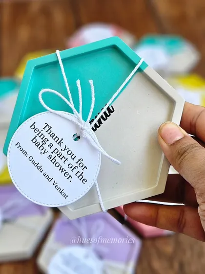A close-up of one of the personalized name coasters. These are handcrafted from eco-resin and make for a thoughtful and unique party favor for any special occasion.
