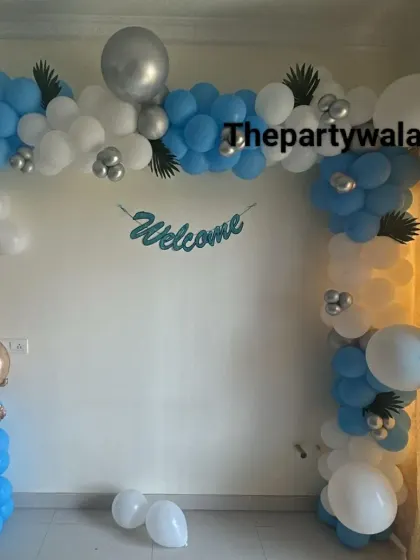 Another angle of the 'Welcome' home balloon decoration, showing the full arch.