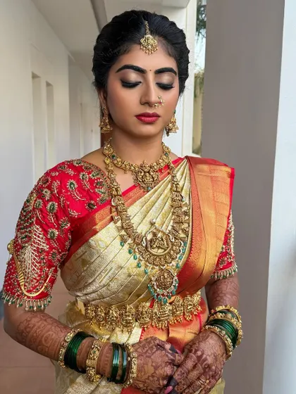 A close-up of Nisarga's bridal makeup. The focus is on the bold red lips and the beautifully blended eye makeup, creating a classic and unforgettable look.