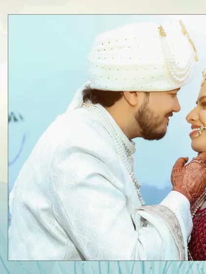 A close-up, intimate portrait of the groom lovingly touching the bride's chin. This shot beautifully captures the affection and tenderness between the couple.