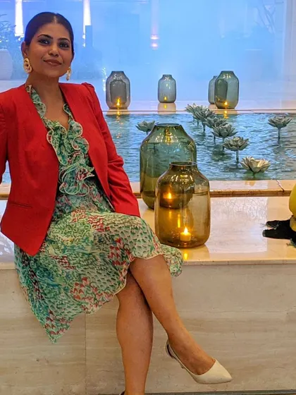 A printed dress can be instantly elevated for a more formal or dressy occasion by adding a structured blazer. Here, I've paired a green floral dress with a bold red blazer for a powerful color-blocked look.