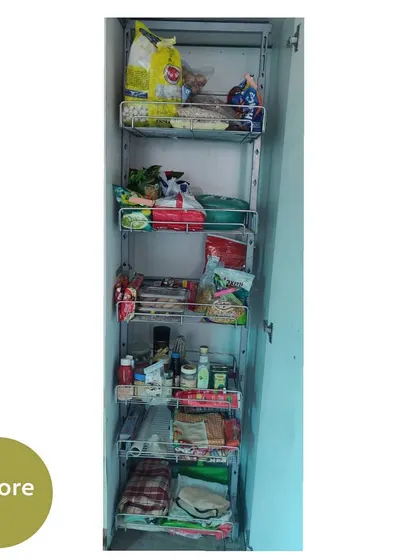 A tall pantry unit before organizing. The items are placed randomly on the shelves, making it hard to see what's in the back.