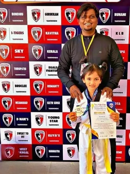 Another look at our young gold medalist, proudly displaying her certificate and medal.
