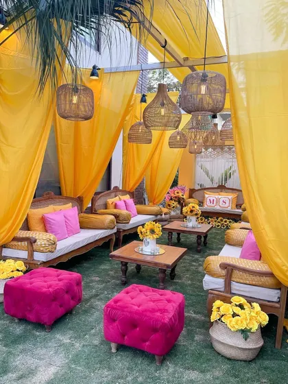 A full view of the intimate Roka seating area. The vibrant yellow drapes create a tent-like feel, making the space feel cozy and festive.