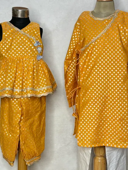 A closer look at the beautiful fabric and design of our yellow brocade sibling set, perfect for a Haldi ceremony or festive puja.