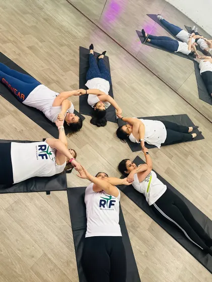 A beautiful star formation created by our members holding hands and feet. This group pose from our International Yoga Day celebration is a perfect example of the unity and connection we foster.