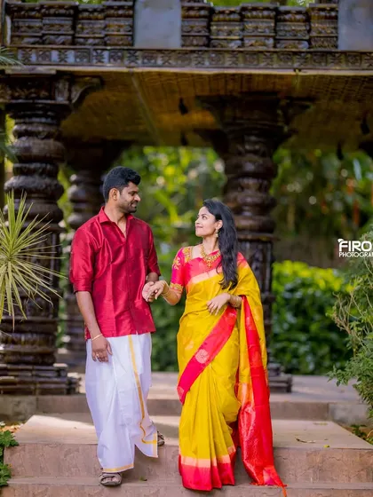A candid moment of a couple walking hand-in-hand in a heritage location. Their traditional attire and the beautiful setting make for a timeless pre-wedding photo.