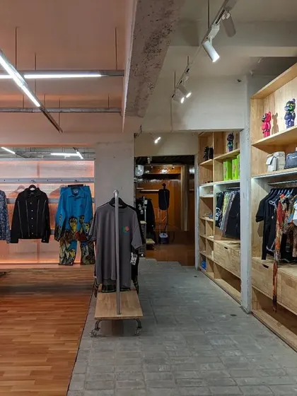 A view down one of the "alleyways," with wooden shelving on one side and backlit displays on the other, creating a varied shopping experience.