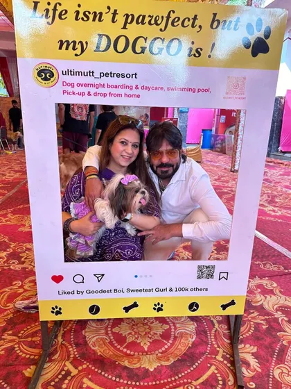 A happy family gets their picture taken in our "pawfect" photo frame. It is a fun way to capture the memory of celebrating Durga Puja with their beloved dog.