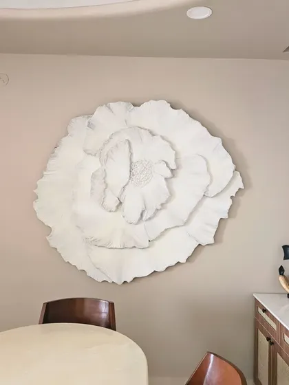 The same floral installation without the backlighting, showcasing its sculptural quality in natural daylight. The texture and form create beautiful shadows on their own.