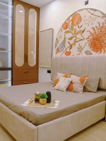 This bedroom showcases a beautiful hand-painted floral mural within an arch, serving as a stunning, artistic headboard.
