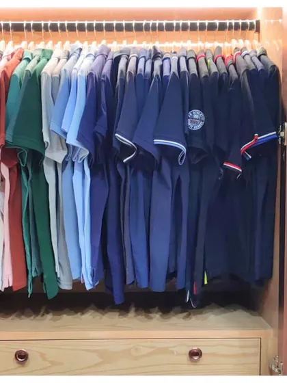 A simple way to maintain order is by color-coordinating your clothes. This rack of polo shirts is arranged in a gradient, which is not only visually pleasing but also makes finding a specific color quick and easy.