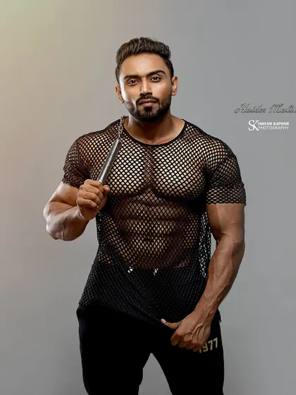 A professional shot in a mesh shirt, showing that you can be muscular and stylish.