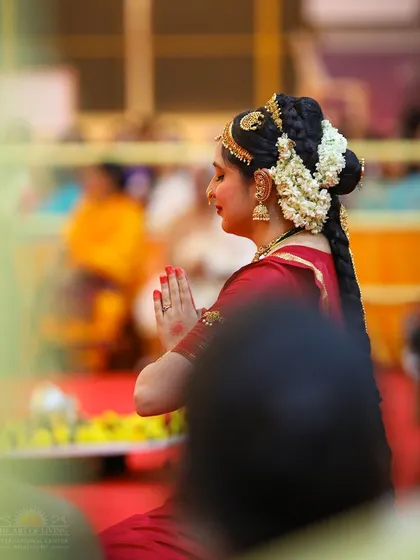 A devotee in traditional dance attire offers her prayers during the Maha Sudarshan Homa. Art and devotion are beautifully intertwined in our celebrations.