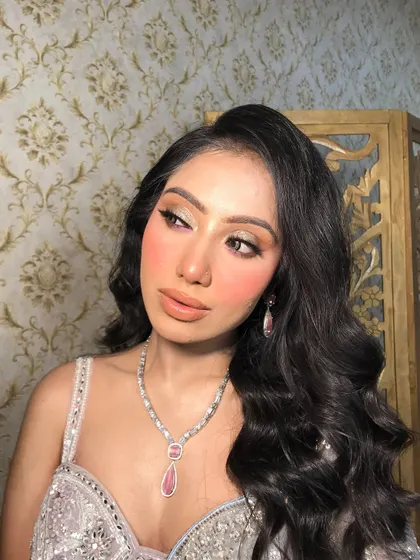 A close-up of this client's look, featuring a delicate pink-stoned American diamond necklace and matching drop earrings.