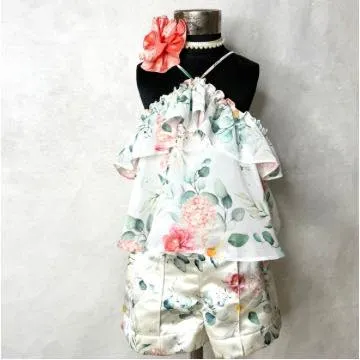 This floral holiday set is perfect for a warm-weather getaway, combining a breezy, ruffled top with comfortable and stylish printed shorts.