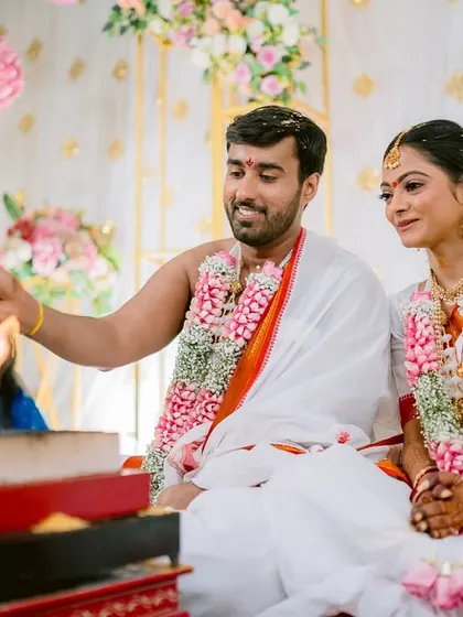 The couple making offerings to the sacred fire, a central part of their wedding ceremony.