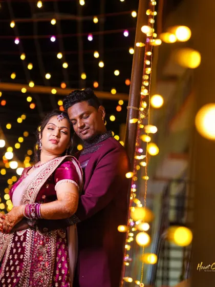 A romantic embrace amidst a backdrop of beautiful bokeh lights. The warm glow creates a magical and intimate atmosphere for the couple.